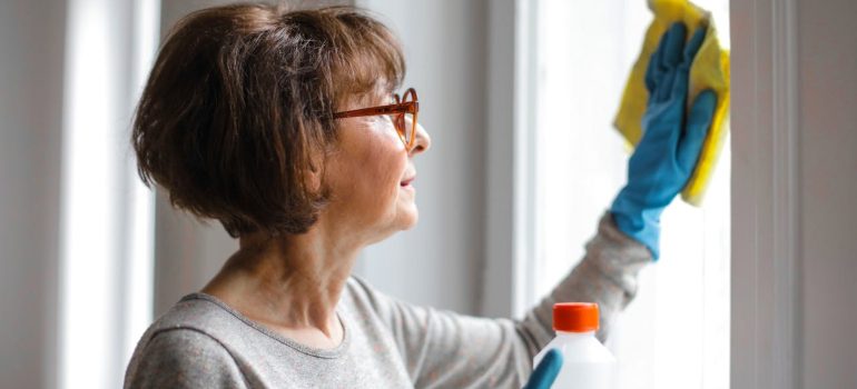 a woman cleaning her apartment before moving out