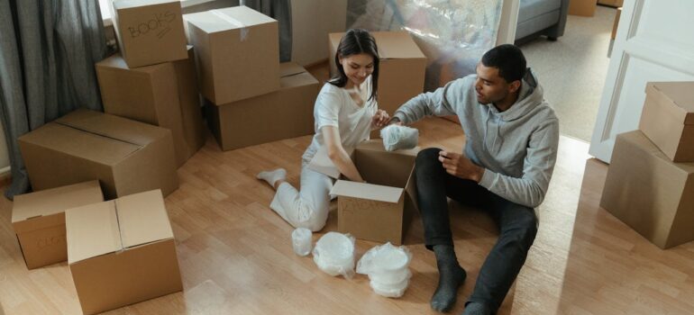 man and woman packing boxes and trying to prepare for a Toronto relocation