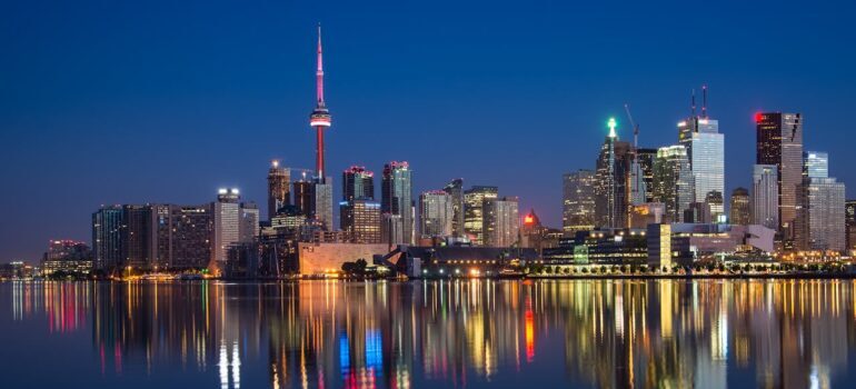 Buildings Near Body Of Water At Night